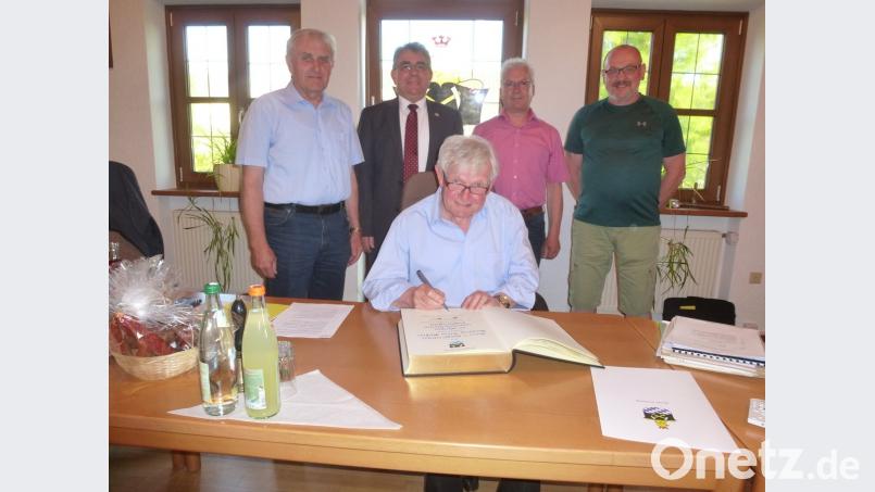 Marktrat Klaus Meißner (vorne) trägt sich ins Goldene Buch der Marktgemeinde ein. Zum 40-jährigen Jubiläum gratulierten (von links) Helmut Klier (FW), Bürgermeister Norbert Bücherl, Helmut Wurzelbacher (CSU) sowie Johannes Otto von der SPD.  	Bild: bk