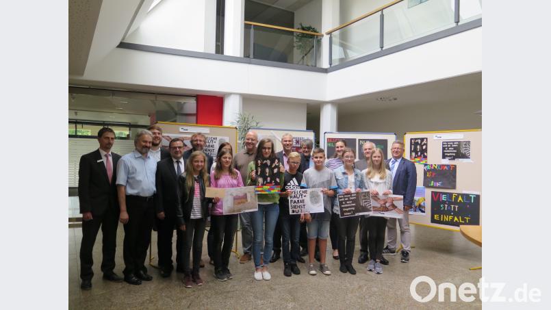 Nicht nur Realschulrektor German Helgert und stellvertretender Landrat Günter Kopp (hinten von rechts) bewundern die Ergebnisse des Plakatwettbewerbs bei der Eröffnung der Ausstellung in der Sparkasse Oberpfalz Nord. Mit ihren sehr kreativ gestalteten Arbeiten wollen die Preisträger (vorne) die Betrachter zum Nachdenken anregen. jzk