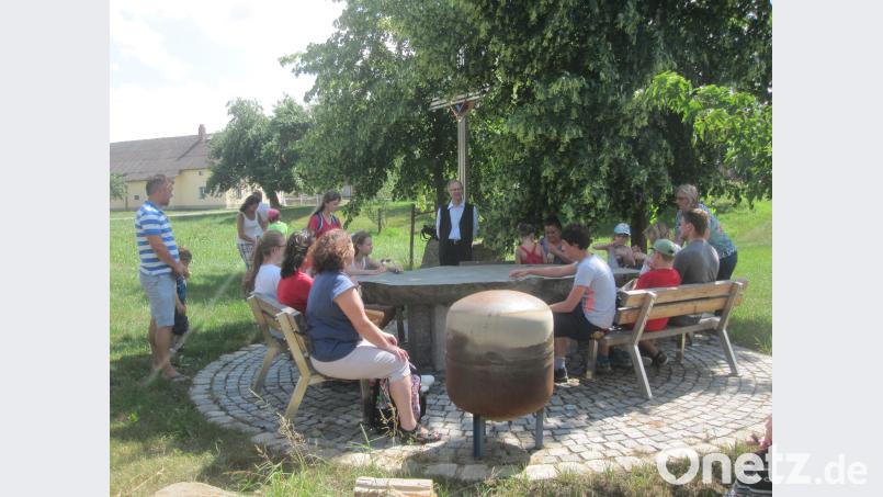 Innehalten der Gemeindepilger bei strahlendem Sonnenschein am neugestalteten Escheldorfer Dorfplatz und –kreuz. exb