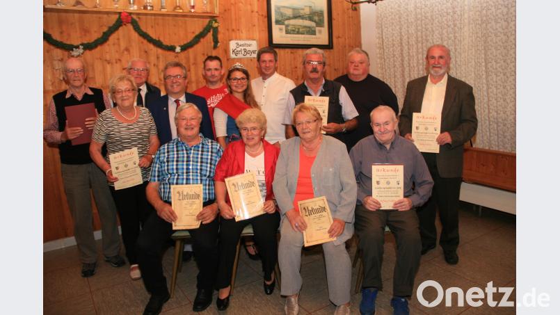 Zum Ehrenmitglied wurde Franz Kraus (stehend links) ernannt. Reinhard Loos (stehend, 2. von links) ist fortan Ehrenvorstand des ESC. Mit Nadeln und Urkunden wurden viele weitere Mitglieder ausgezeichnet. „Weißbier-Resi“ Martina Bleistein (5. von rechts), 2. Bezirksobmann Steve Weiß (4. von rechts) und Bürgermeister Toni Dutz (4. von links – jeweils stehend) gratulierten den Geehrten. wro