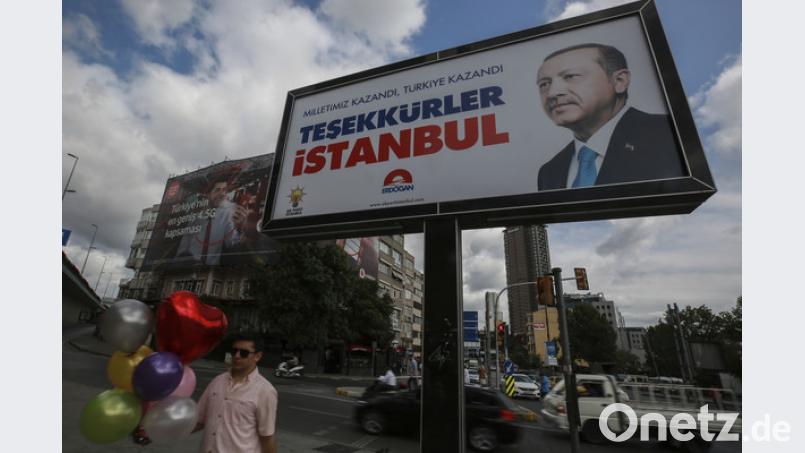 Ein Plakat mit einem Bild des Staatspräsidenten Erdogan ist ein Tag nach den Wahlen in der Türkei vor einem bewölkten Himmel zu sehen. Trotz Manipulationsvorwürfen der Opposition hat sich der türkische Staatspräsident noch vor dem Ende der Auszählung zum Sieger der Präsidentenwahl erklärt. Emrah Gurel/AP/dpa