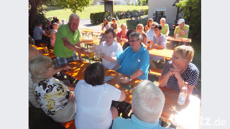 Fördervereinsvorsitzender Günter Winter (stehend) freute sich mit Pfarrer Dr. Roland Kurz und Diakonin Irene Elsner (rechts neben ihm) über das gelungene Gemeindefest. ibj