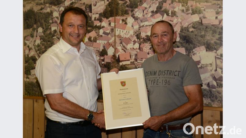 Bürgermeister Anton Kappl (links) überreicht Hermann Gebhardt für seine zehnjährige Tätigkeit als Marktrat eine Dankurkunde. bey