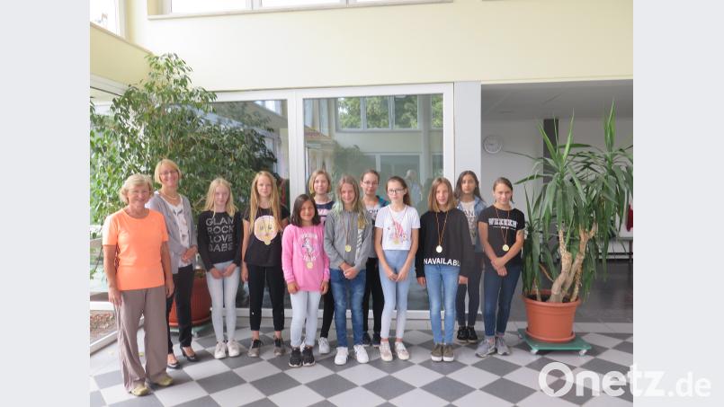 Sportlehrerin Birgit Emerig und Schulleiterin Christine Wiesend (von links) gratulieren den zehn besten Mädchen: Leonie Bauer (6. Klasse), Fiona Janisch (6), Leonie Fehn (5b), Evelyn Weber (6), Celine Kastner (6), Luisa Bauer (6), Viktoria Krieger (6), Saskia Schüler (5a), Rojin Hazim (5a), Carina Luckas (5a). jzk