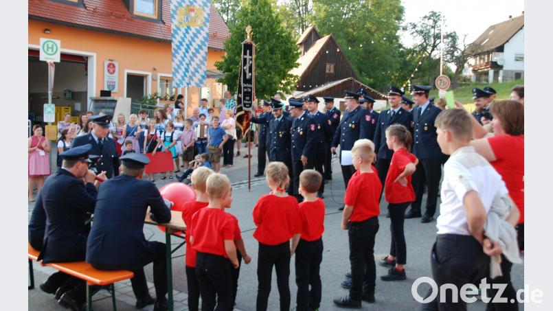 Die Feuerwehr Kühried (rechts) gab erst nach vier bestandenen Aufgaben die Zusage zur Übernahme der Ehrenpatenschaft. Die Kührieder Festdamen feuerten vorm Gerätehaus mit Gstanzln an. Portner