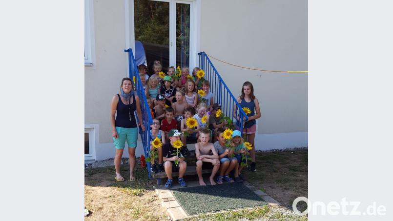 Die Kinder der Turngruppe „Fitte Kids“ – erste bis dritte Klasse – danken mit Sonnenblumen den Helfern. exb