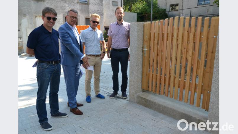 Stadtbaumeister Andreas Ockl, Bürgermeister Franz Stahl, Straßenbaumeister Michael Dörfler und stellvertretender Kämmerer Harald Eckstein (von links) begutachten das Ergebnis des altstadtgerechten und barrierefreien Ausbaus der Ringstraße. Die Gruppe steht an der engsten Stelle der Straße, die vor der Sanierung noch enger war. Durch den Abriss eines baufälligen Hauses konnten etwa 60 Zentimeter für die Altstadtgasse gewonnen werden. Jetzt passen auch Rettungs- oder Müllfahrzeuge durch das Nadelöhr. Auf dem Grundstück dahinter entstehen begrünte Parkplätze. szl