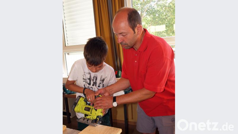Hans Ram hilft Adrian beim Abschrägen mit der Stichsäge. Bild: sön