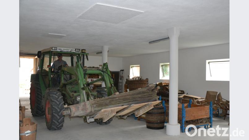 Herbert Konrad transportiert das historische Blasebalg mit dem Traktor in das neue Domizil. 200 Quadratmeter Platz bietet die Lagerhalle. Bild: plym