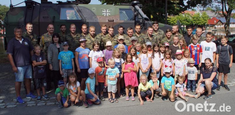Vor "Dingo", dem Allschutz-Transportfahrzeug der Bundeswehr, stellten sich die Kinder mit Norbert Veitenhansl (links), den Angehörigen der Patenkompanie in der Grenzlandkaserne und Bürgermeisterin Birgit Höcherl zum Gruppenbild. Bild: mmj