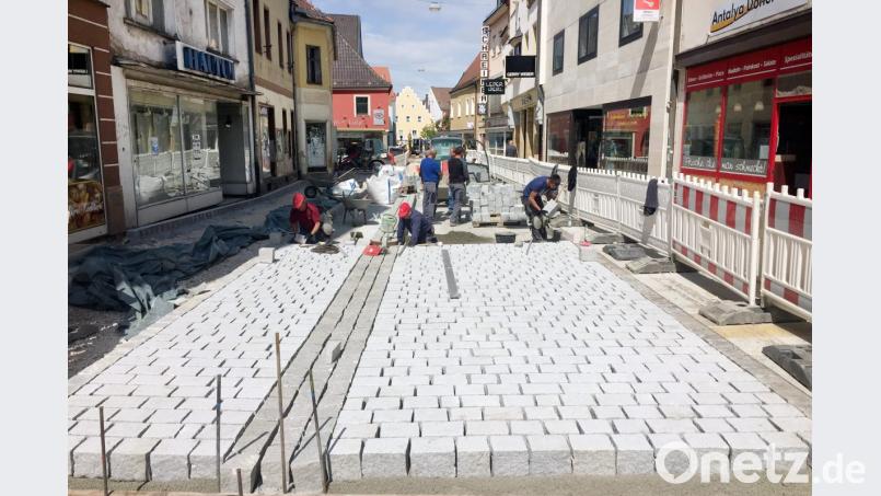Im ersten Bauabschnitt ist schon zu erkennen, welches Bild die Friedrich-Ebert-Straße in Schwandorf künftig bieten wird. Sie soll zur attraktiven Einkaufsmeile werden, mit relativ wenig Verkehr. Die breite Spur rechts dient künftig dem Fahrzeugverkehr, links neben dem dunklen Dreizeiler verläuft die Radspur. Abgetrennt durch dunkle Einzeiler folgen rechts und links die Gehwege. Hochbord gibt’s dann nicht mehr. Bild: Gerhard Götz