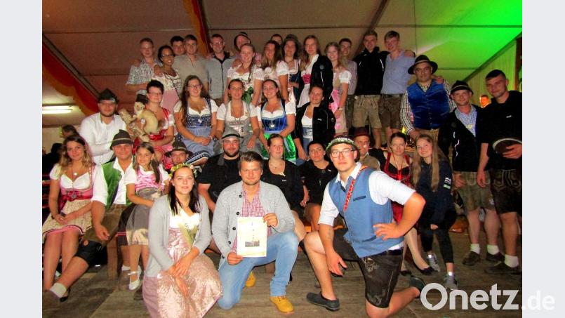 Fabian Lessau hält das Bild des Kirwabaums in den Händen, den er gewonnen hat. Mit ihm freuen sich die Wellucker Kirwaleit'. Bild: sck