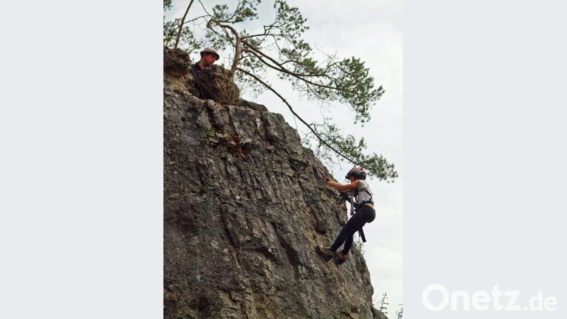 Von Johannes Haas (oben) eingewiesen und gut gesichert mit Seil und Sicherheitshelm waren die Kids beim Klettern am Holzfelsen. Bild: sön