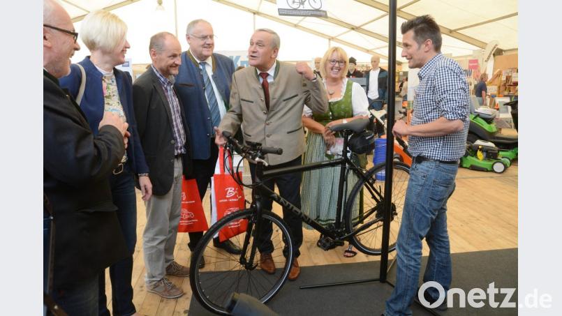 Da schau her, dürften die Besucher der Gewerbeausstellung öfter sagen. Das Angebot ist bunt. Hier greift sich OB Kurt Seggewiß gerade ein E-Bike. Dahinter warten Rasenmäher, Grills, Schmuck und mehr. Bild: Gabi Schönberger