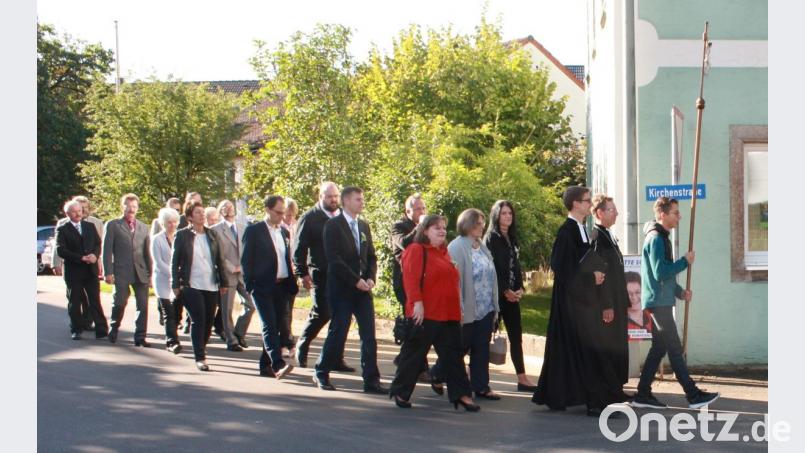 Vom Gemeindehaus ziehen die Jubelkonfirmanden mit den Pfarrern und Kirchenvorstehern zum Gotteshaus. Bild: lk