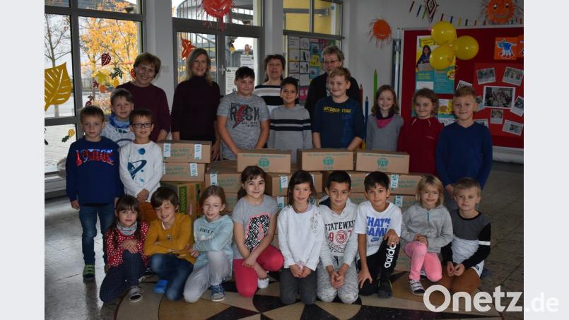 Stolz präsentieren die Vertreter der Kinder der acht Klassen der Grundschule die gepackten Pakete. Bild: adj