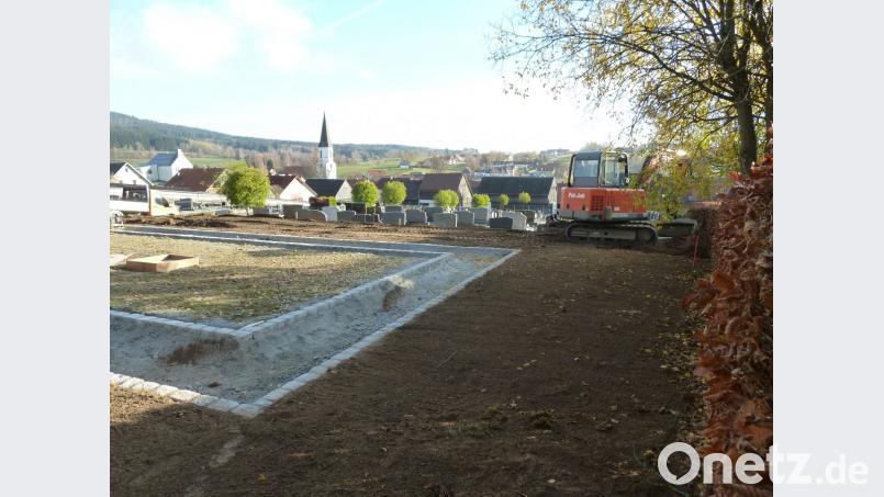Im Friedhof Schönsee entsteht ein Urnenfeld mit bodengleichen Platten (Mitte). Außerhalb des Gehweges, der den Platz in U-Form erschließen wird, ebnet der Bauhof derzeit das Gelände für Urnenstätten mit traditionellen Grabsteinen. Bild: Portner