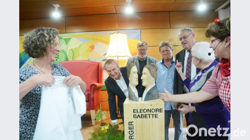 Et voilà: So also sehen Eleonore und Babette Sindersberger aus. Holzbildhauerin Irene Meier (links) enthüllt „Unter der Leselampe“ die Köpfe. Da schauen Putzperle Frau Huber (von rechts), Heimsprecherin Anneliese Hein, Bürgermeister Lothar Höher, Stadtrat und Sindersberger-Verwandter Rainer Sindersberger, Heimleiter Wolfgang Reuter sowie Diakon Karl Rühl genau hin. Bild: Gabi Schönberger