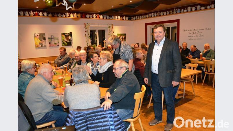 Gut besuchte Bürgerversammlung in der Hofkäserei Lang in Oed. Bürgermeister Gerhard Kellner (stehend) informiert über die aktuelle Gemeindepolitik. Bild: Schmola, Werner