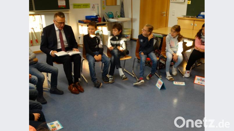 Erster Bürgermeister Franz Stahl liest die Geschichte „Nachts sind alle Katzen grau? Warum sieht man nachts keine Farben? aus dem Buch „Wo ist die Sonne in der Nacht? – Vorlesegeschichten für neugierige Kinder“. Bild: exb