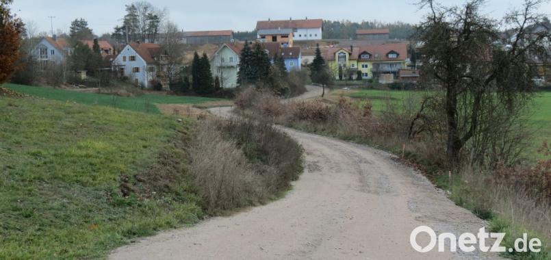 „Am Kalvarienberg“ zwischen den Baugebieten „Am Hütberg“ und „Am Weinberg“ (im Hintergrund) plant der Markt linker Hand des geschotterten Notwegs die Ausweisung eines Baugebiets mit voraussichtlich fünf Bauparzellen. Bild: Köppl