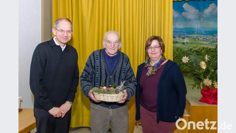 Beim Seniorennachmittag überreichten Stadtpfarrer Johann Hofmann (links) und PGR-Sprecherin Theresa Meindl ein Präsent an Richard Mages und dankten für die langjährige Mitarbeit beim Pfarrfest. Bild: wms