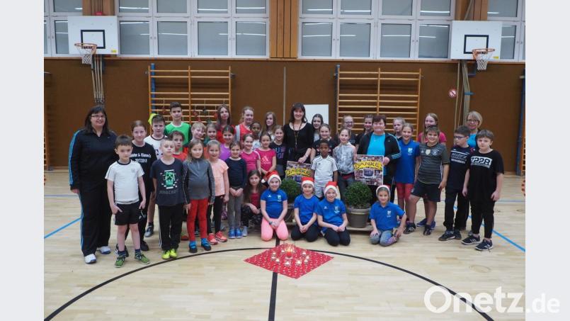 Die beiden langjährigen Kinderbetreuerinnen Christa Würfl und Sonja Spangler werden in der letzten Turnstunde mit Buchsbäumchen und Bildercollagen überrascht. Bild: gz