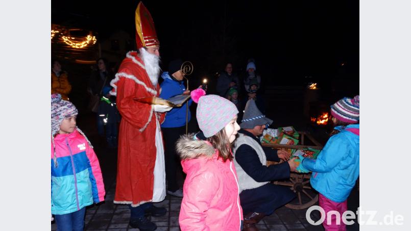 Zum wiederholten Mal kommen die Kinder des Sportvereins Trevesen auf den weihnachtlich geschmückten Hof der Familie Lorenz. Nikolaus und Knecht Ruprecht verteilen an sie Süßigkeiten. Bild: twg