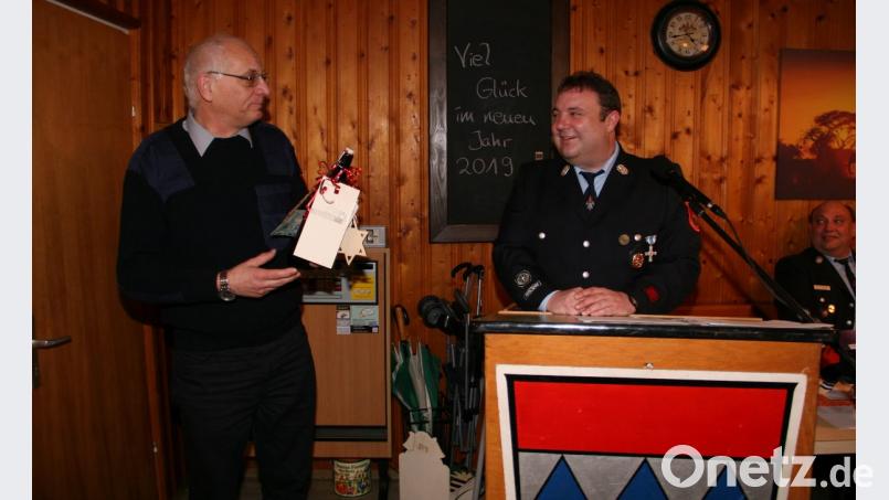 Anton Adam (links) bekam vom Vorsitzenden Matthias Reul einen Zoigl-Reisegutschein überreicht. Auch nach seiner Vollendung des 60. Lebensjahres engagiert sich Adam für seine Feuerwehr. Bild: wro