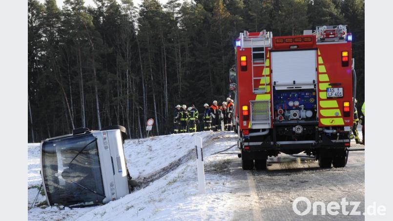 Auf schneeglatter Straße kommt der Schulbus von der Straße ab, kippt um und bleibt im angrenzenden Acker liegen. Bild: gf