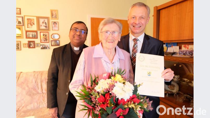 Zweiter Bürgermeister Thorsten Grädler und Pfarrvikar Madanu überbringen der Jubilarin ihre Glückwünsche. Bild: Stefanie Gradl