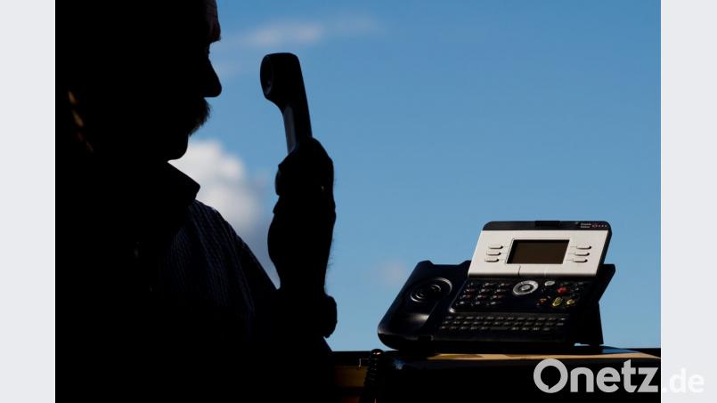 Ein Mann hält einen Telefonhörer in der Hand. Foto: Julian Stratenschulte/Archiv Bild: Julian Stratenschulte