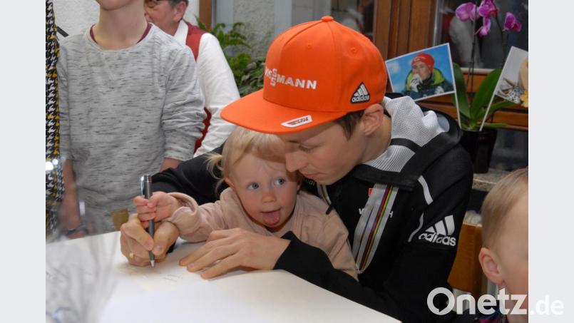 Emma bei ersten Schreibübungen mit dem Papa: Eric Frenzel trug sich zusammen mit seiner kleinen Tochter ins Goldene Buch der Gemeinde Flossenbürg ein. Bild: gb