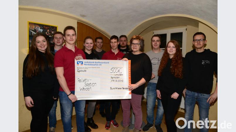 Vorsitzender Peter Bäumler (Dritter von links) übergibt Beate Spickenreuther, Vertreterin der Palliativstation Weiden (Vierte von rechts) im Beisein des Vorstands den symbolischen Scheck über 500 Euro. Bild: bey