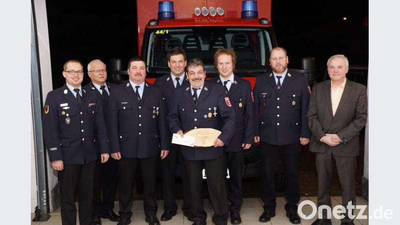 Nicht auf Papier, sondern auf einer Holzscheibe ist die Ernennung von Wolfgang Schmidt (Mitte) zum Ehrenkommandanten niedergeschrieben. Für 34 Jahre Verantwortung Ehren ihn (von links) Florian und Otto Braunreuther, die Vorsitzenden Alexander Schraml und Markus Felix, Alexander Kausler, zweiter Kommandant Tobias Kreuzer und Bürgermeister Günter Kopp. Bild: bkr