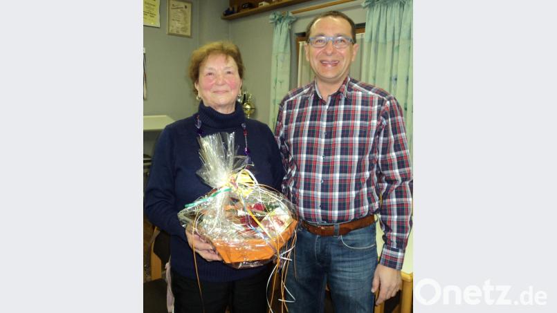 Vorsitzender Manfred Bösl bedankt sich bei Anna Prechtl mit einen Geschenkkorb für 40 Jahre gewissenhafte Kassenführung. Bild: ksi