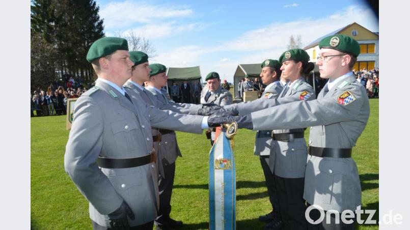 Mit der Hand auf der Truppenfahned sprechen die Soldaten auf dem Sportplatz in Tännesberg das Gelöbnis. Bild: fz