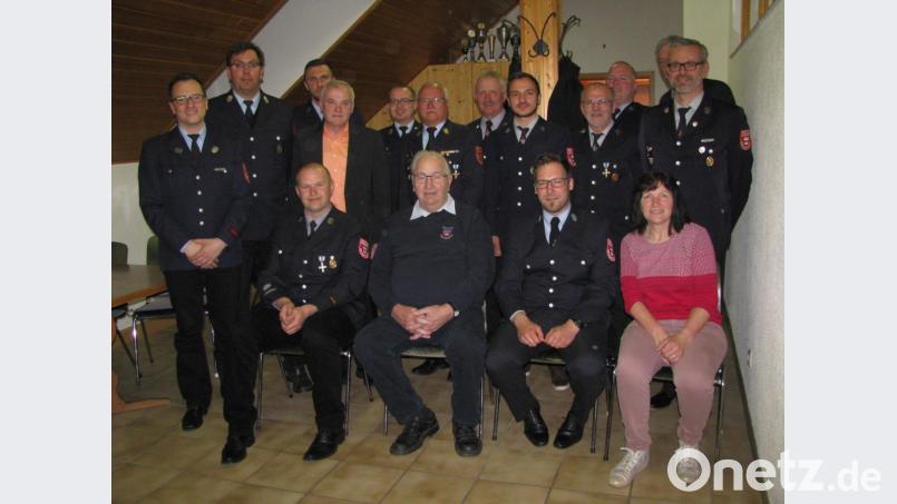 Andreas Schultes (sitzend, Zweiter von links) wird zum Ehrenvorsitzenden der Oberwappenöster Feuerwehr ernannt. Dazu gratulieren ihm unter anderem Kreisbrandinspektor Otto Braunreuther (stehend, Mitte) und Bürgermeister Günter Kopp (stehend, Vierter von links). Bild: exb