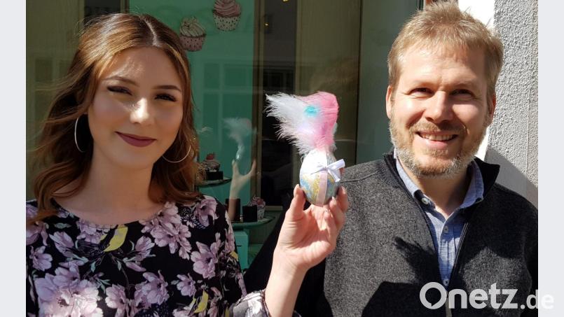 Claudia Janotta (23) lebt in Parkstein und hat dieses marmorierte und mit Dekoband und Federn verzierte Ei gestaltet. Die Mitarbeiterin von Goldschmiede Gruhle in Weiden präsentiert es zusammen mit Stefan Gruhle (43). Bild: Sonja Kaute