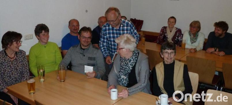 OGV-Vorsitzender Karl Ruhland (stehend) referierte über insektenfreundliche Gärten. Dazu stellte er den Mitgliedern eine Saatmischung des Landesverbands für eine Blumenwiese vor. Bild: Portner