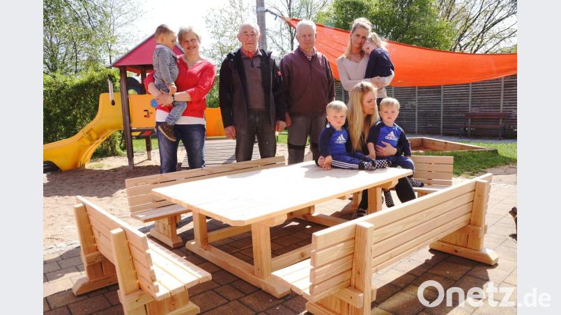 Auch die fünfte Gruppe des Kindergartens hat jetzt einen Platz für eine Brotzeit. Wilhelm König und Albert Melzner (Dritter und Vierter von links) überraschen die Erzieherinnen Michaela Pühl, Nadja Kröniger und Isabel Striegl (von links) mit einer Sitzgruppe. Bild: bkr