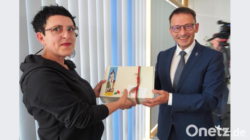 Bürgermeister Jens Meyer übergibt ein Gastgeschenk an die Referentin der achten Demokratie-Konferenz, Annette Seidel-Arpaci von RIAS. Bild: Bühner