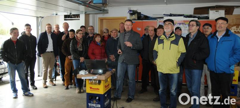 Der Hohenburger Bürgermeister Florian Junkes (Bildmitte) ist nicht nur Energieberater, sondern auch ein überzeugter Nutzer von E-Mobil und PV-Anlage. Er rechnete den Teilnehmern der Landkreis-Tour vor, dass sich eine Investition in Sonnenstromnutzung schon nach wenigen Jahren amortisiert. Bild: gf