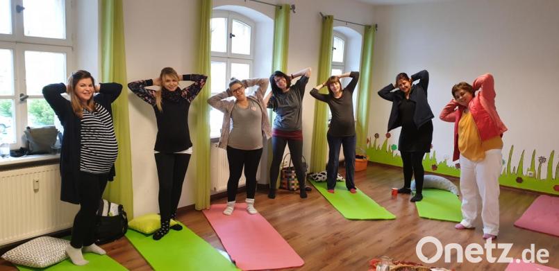 Yogalehrerin Theresa Heining (rechts) erklärt den Schwangeren die Übungen und macht sie vor. Bild: jzk