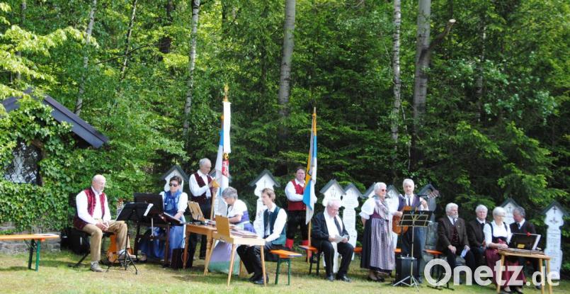 An der OVK-Gedenkstätte feierten die Mitglieder mit Pfarrer Martin Schultes (Bildmitte) eine Andacht. Die Feier gestalteten (von links) die Stubenmusi Maxhütte, das Koller-Duo und die Niedermuracher Sänger. Dahinter stehen die Bannerträger der Volksliedkreise Cham und Schwandorf. Bild: exb