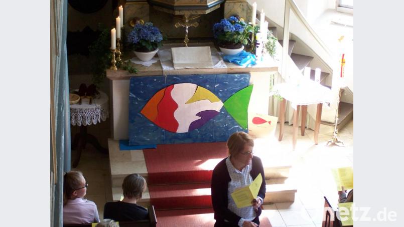 Der Christusfisch ist zusammengesetzt und strahlt vorm Altar. Bild: rrd