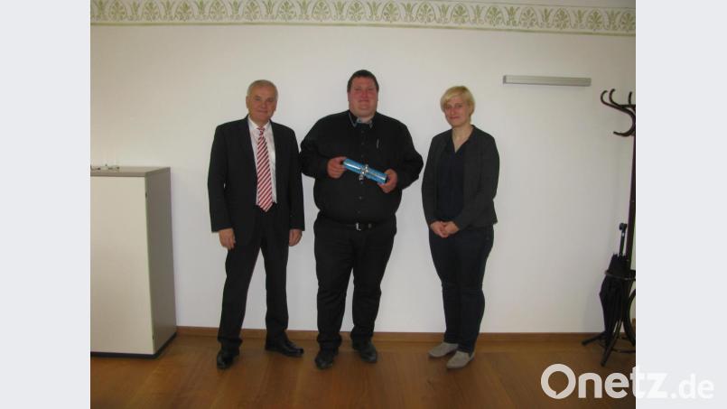 Bürgermeister Günter Kopp (links) und Geschäftsleiterin Kathrin König gratulieren Georg Redl junior mit einem Geschenk zur bestandenen Prüfung als Verwaltungsfachkraft. Bild: exb