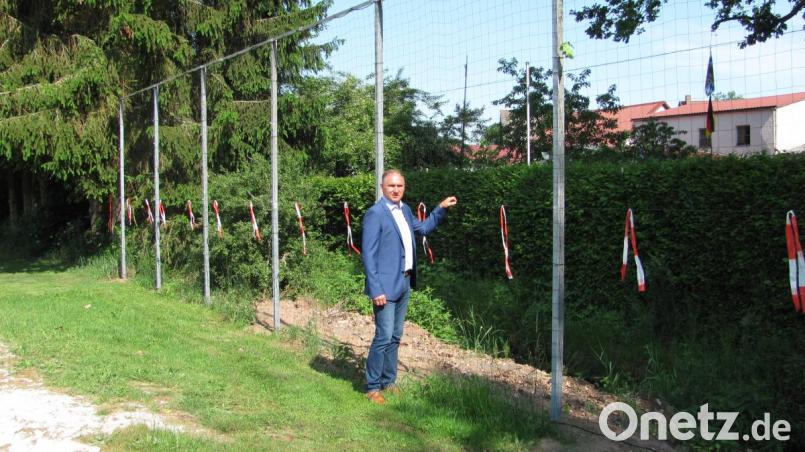 Damit die Beachvolleyball-Spieler nicht immer den Ball aus dem benachbarten Wassergraben fischen müssen, haben die Bauhofmitarbeiter dort ein Fangnetz zur Abgrenzung gebaut. Bürgermeister Richard Kammerer besichtigt das neue Netz. Bild: sei