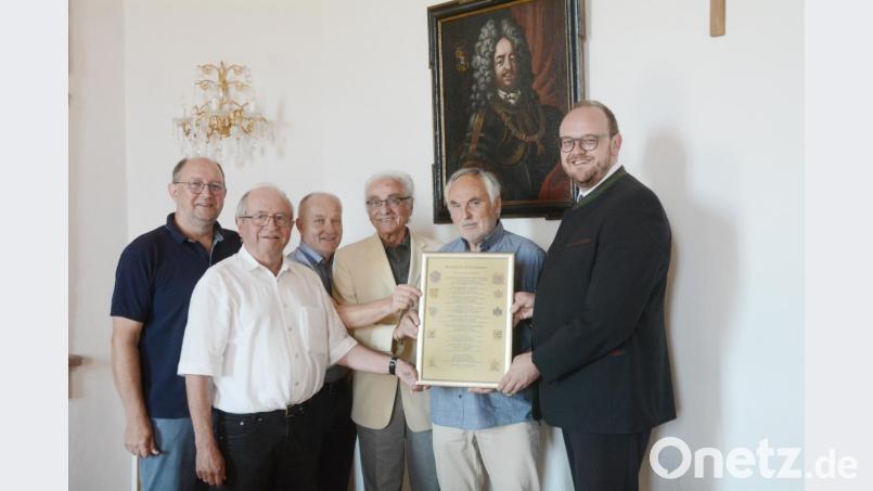 Queen Elizabeth II. stammt nicht nur aus Coburg, sondern auch aus Neustadt/WN ab. Dies haben die Kulturfreunde Lobkowitz im Internet erforscht. Bernhard Knauer, Bernhard Steghöfer, Martin Staffe, Oskar Schwarz und Ernst Umann übergaben die Ahnentafel an Landrat Andreas Meier (von links). Im Hintergrund das Bild von Fürst Ferdinand von Lobkowitz, dem Stammvater des englischen Königshauses. Bild: Gabi Schönberger