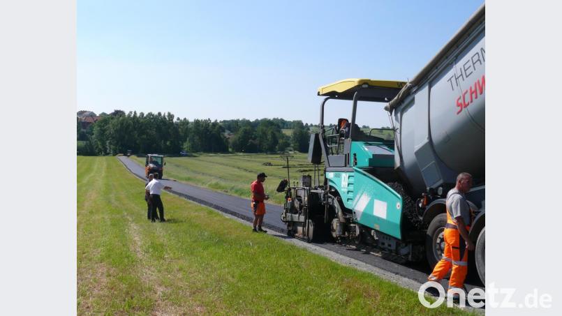Die Asphaltierung der Kößlmühlstraße erfolgte bei brütender Hitze. "Da kommt man schon beim Zuschauen ins Schwitzen", meinte Bürgermeister Andreas Wutzlhofer. Bild: dob